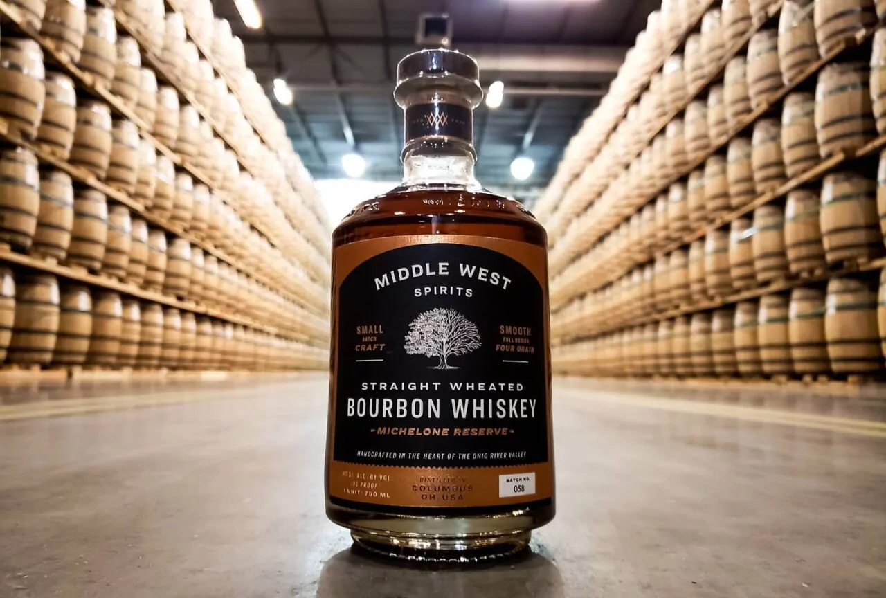 Bourbon Whiskey with custom label and barrels in the background