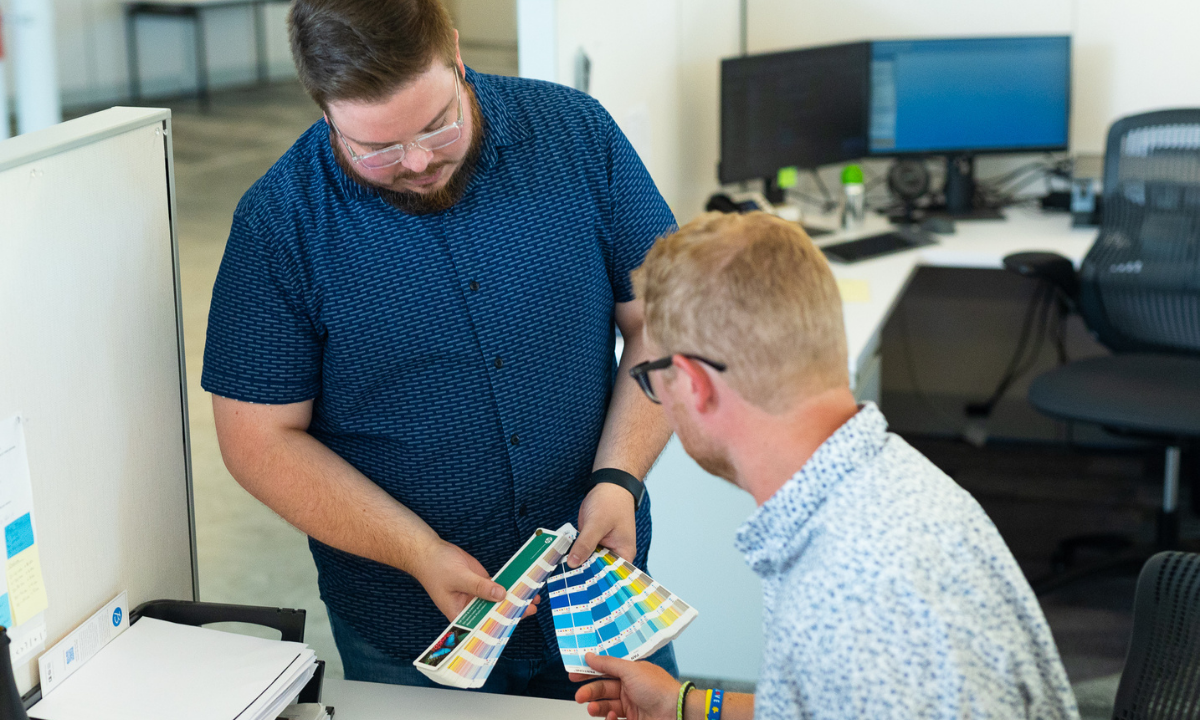 Label designers looking at color swatches